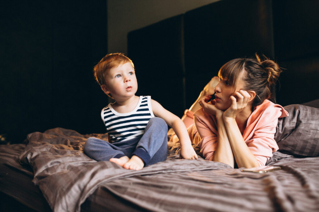 Mother with her son in bed