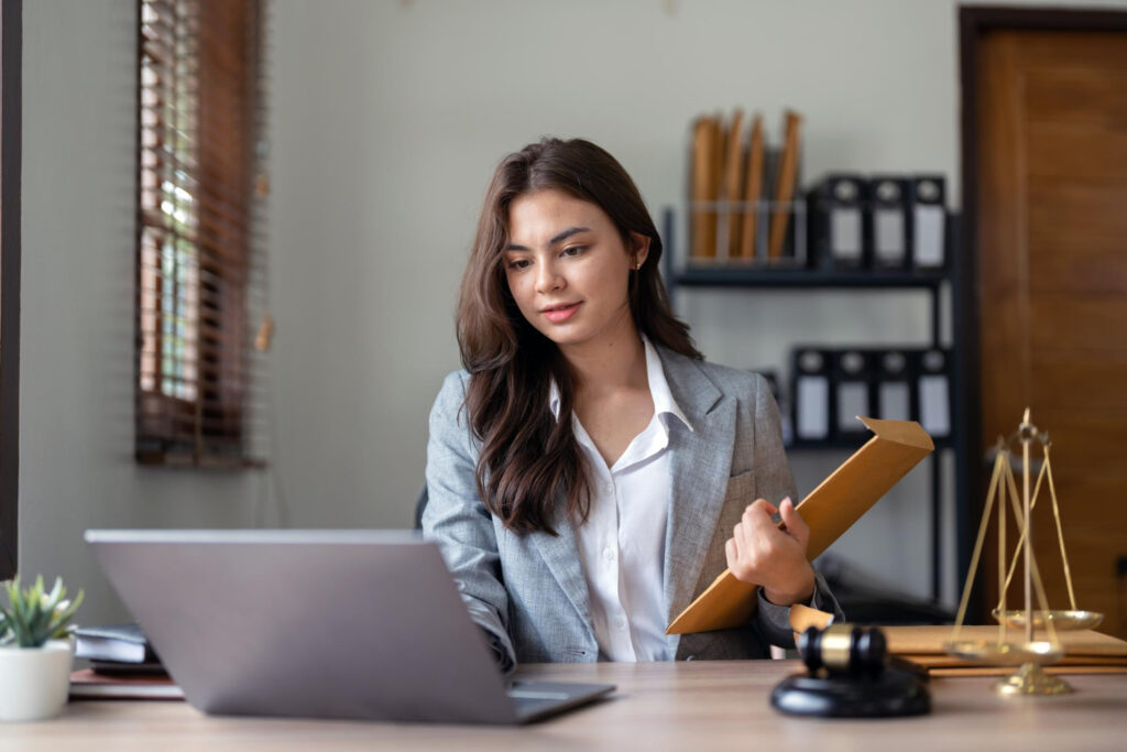 Lawyer working on laptop and documents