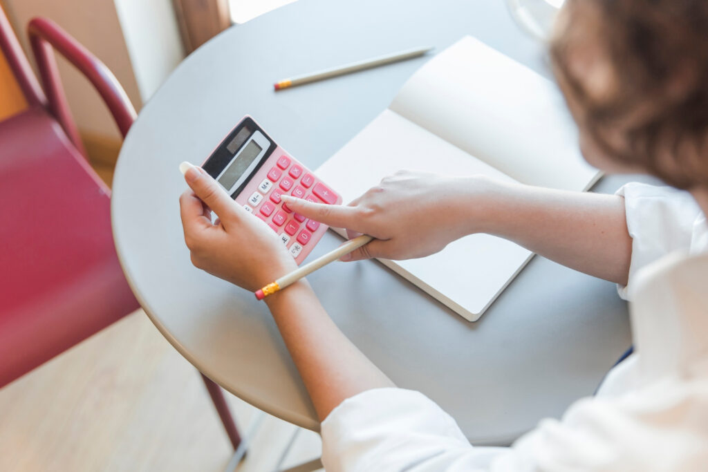 Woman using calculator at table