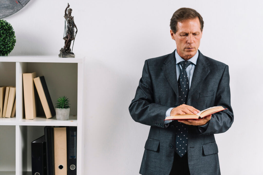 Lawyer reading law book in the office