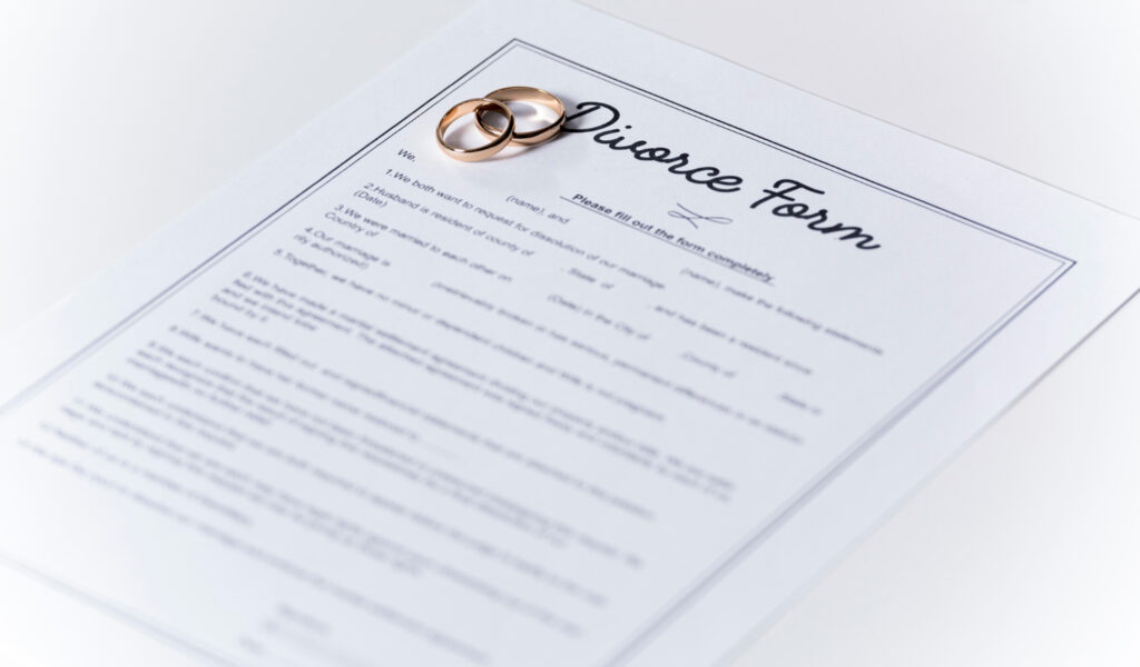 Divorce form with wedding rings on the table