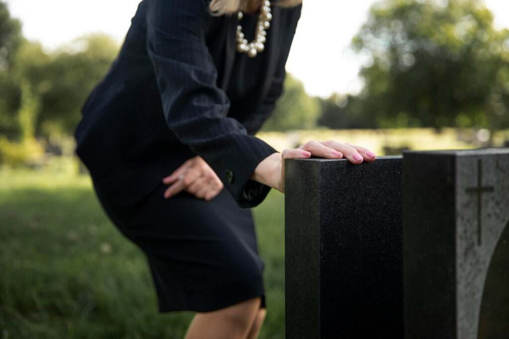 Woman visiting the grave of loved one