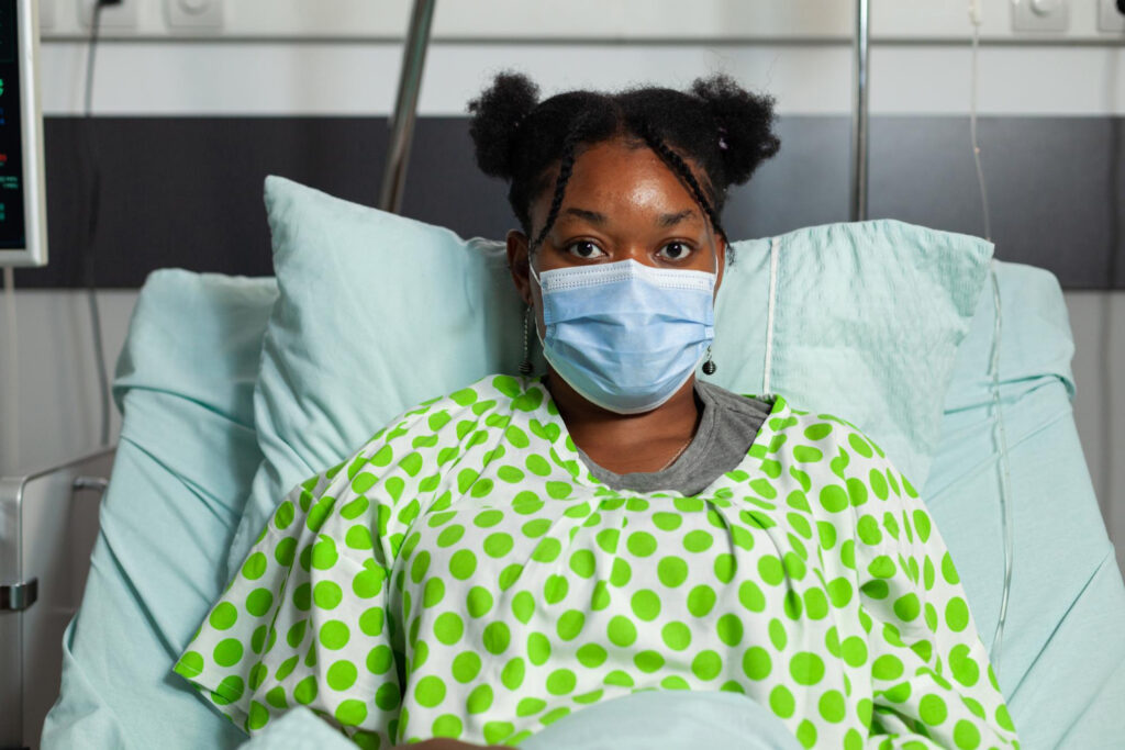 Sick young patient lying in bed