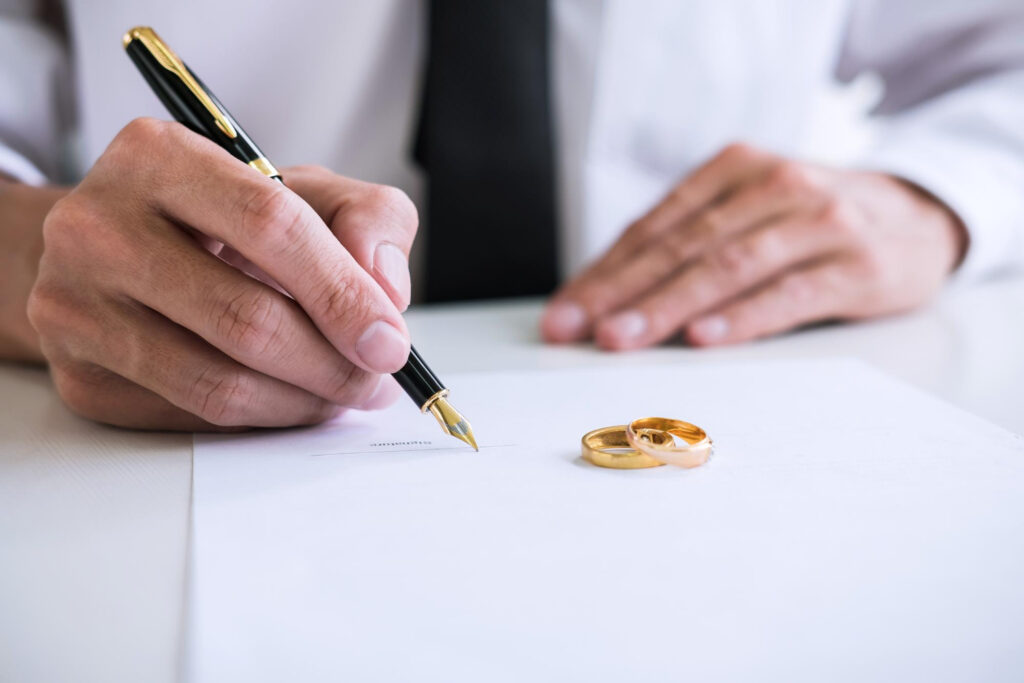 Man signing on divorce paper