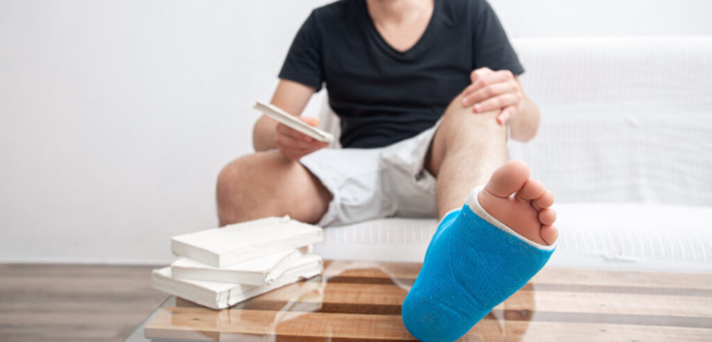 Man with broken leg in blue splint