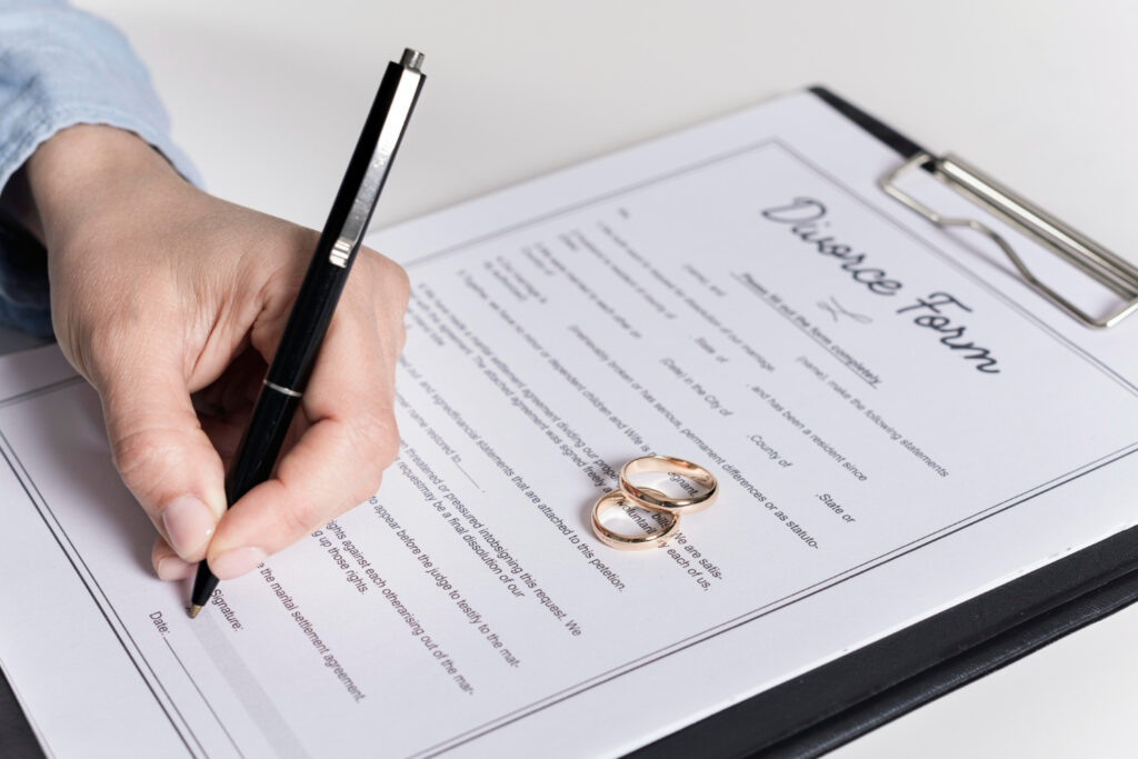 Man signing divorce form