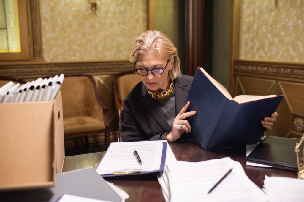 Lawyer with open book looking at document