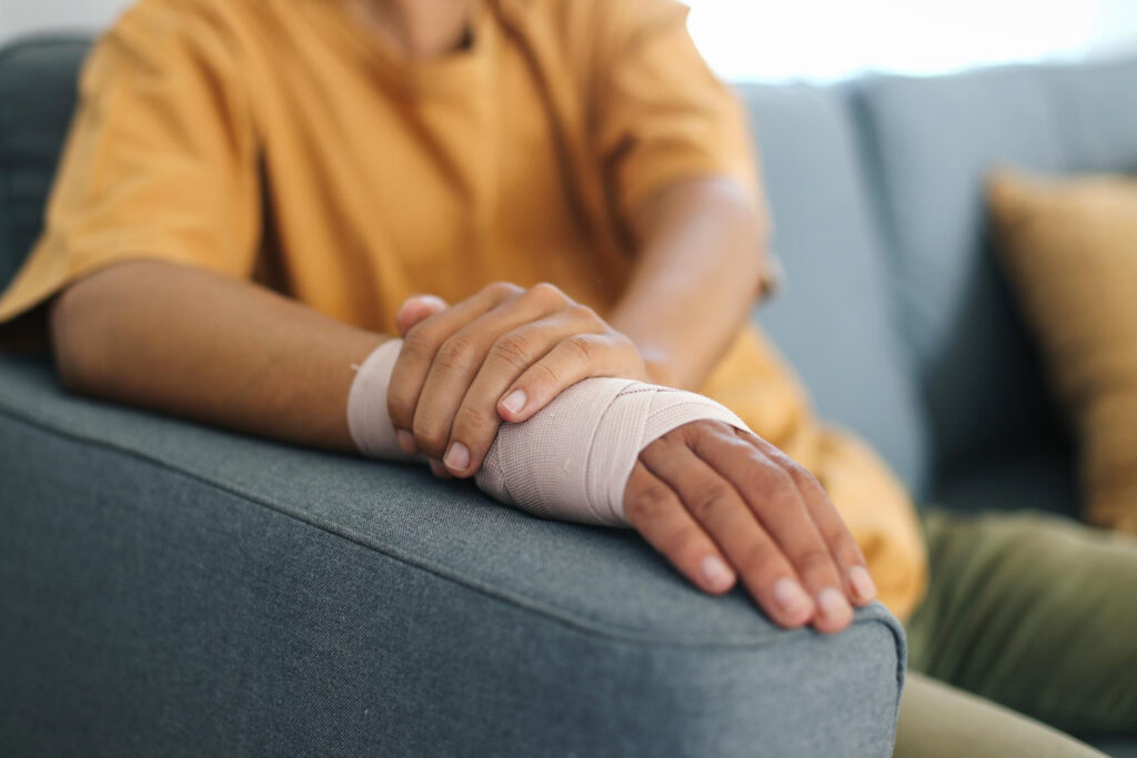 Injured Hand Of Man Wear Wrist Elastic Bandage